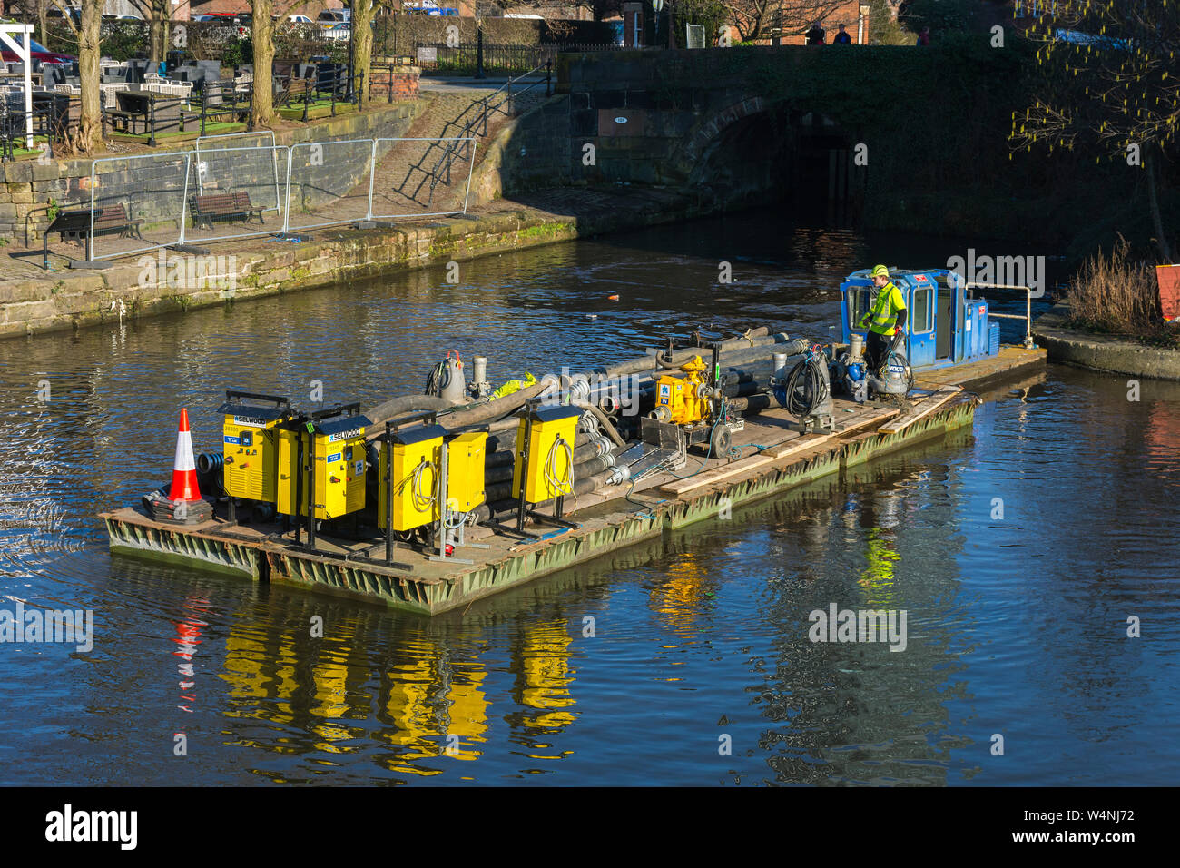 Floating platform with equipment for repairs to lock 92 at the junction of the Bridgewater and Rochdale canals, Castlefield, Manchester, England, UK Stock Photo