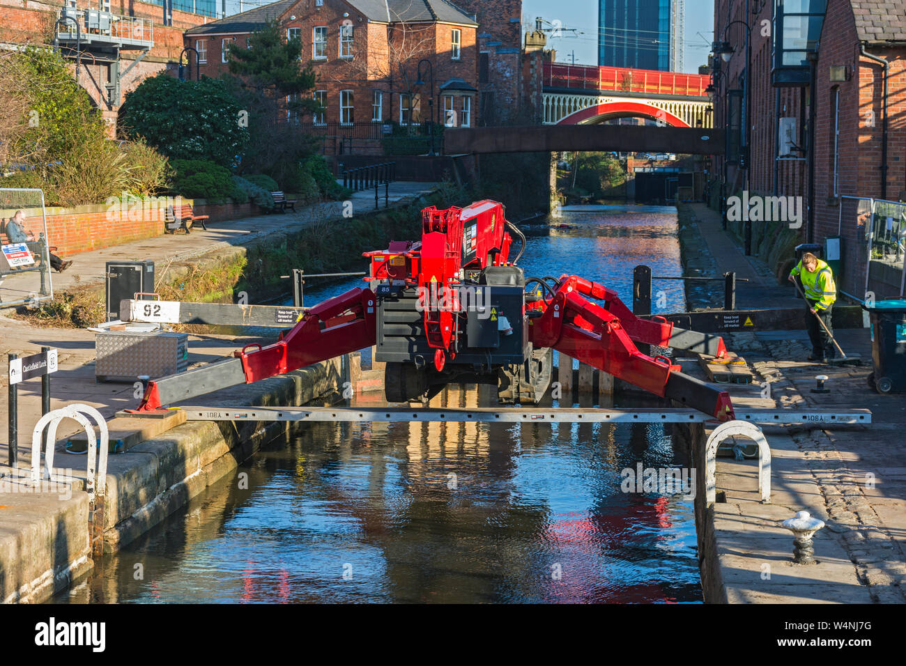 UNIC URW-706 Mini Spider Crane astride lock 92 on the Rochdale canal, at its junction with the Bridgewater canal, Castlefield, Manchester, England, UK Stock Photo