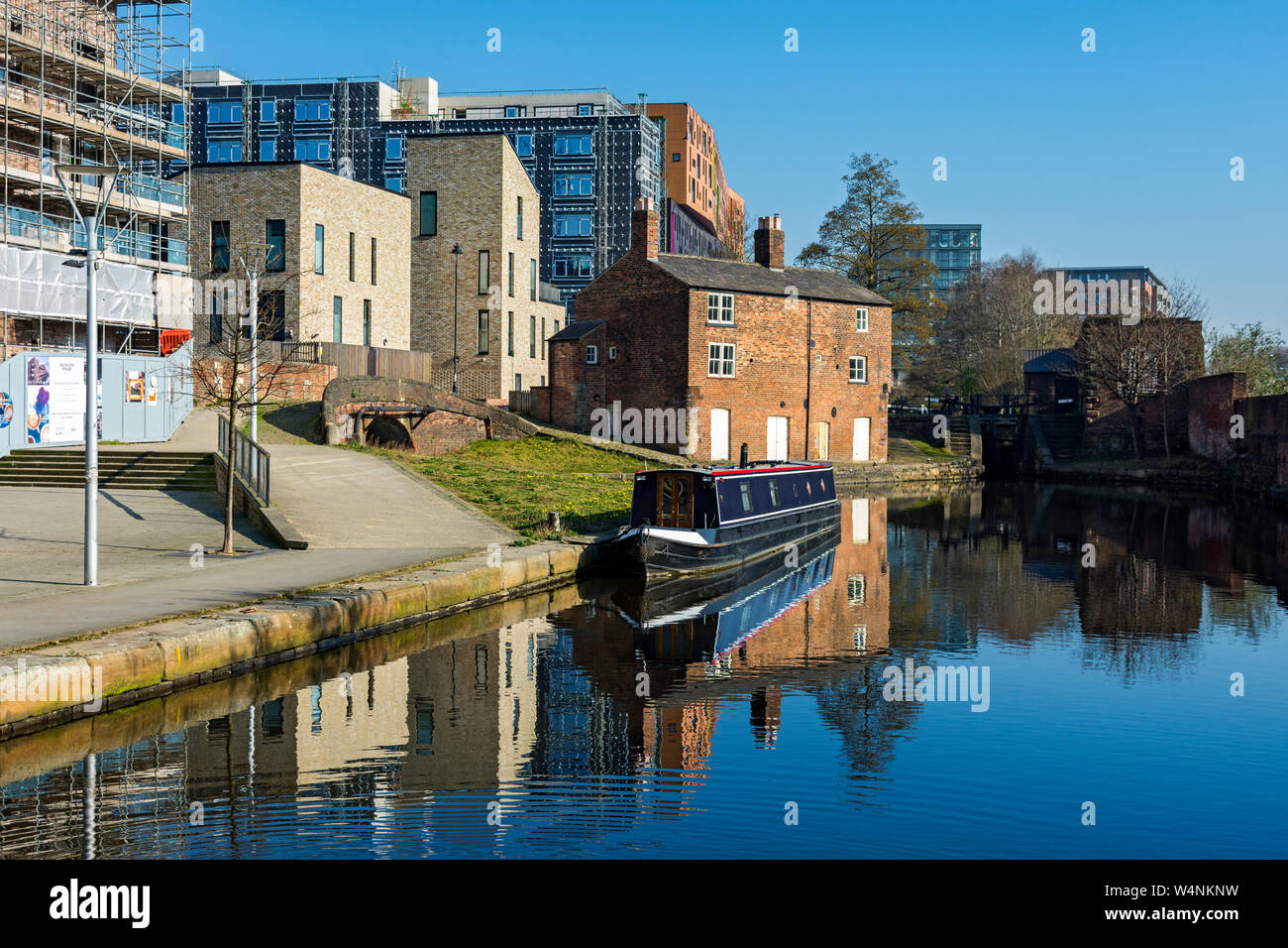 Former lock keeper's cottage and a canal narrowboat on the Ashton Canal, by Islington Wharf Mews
