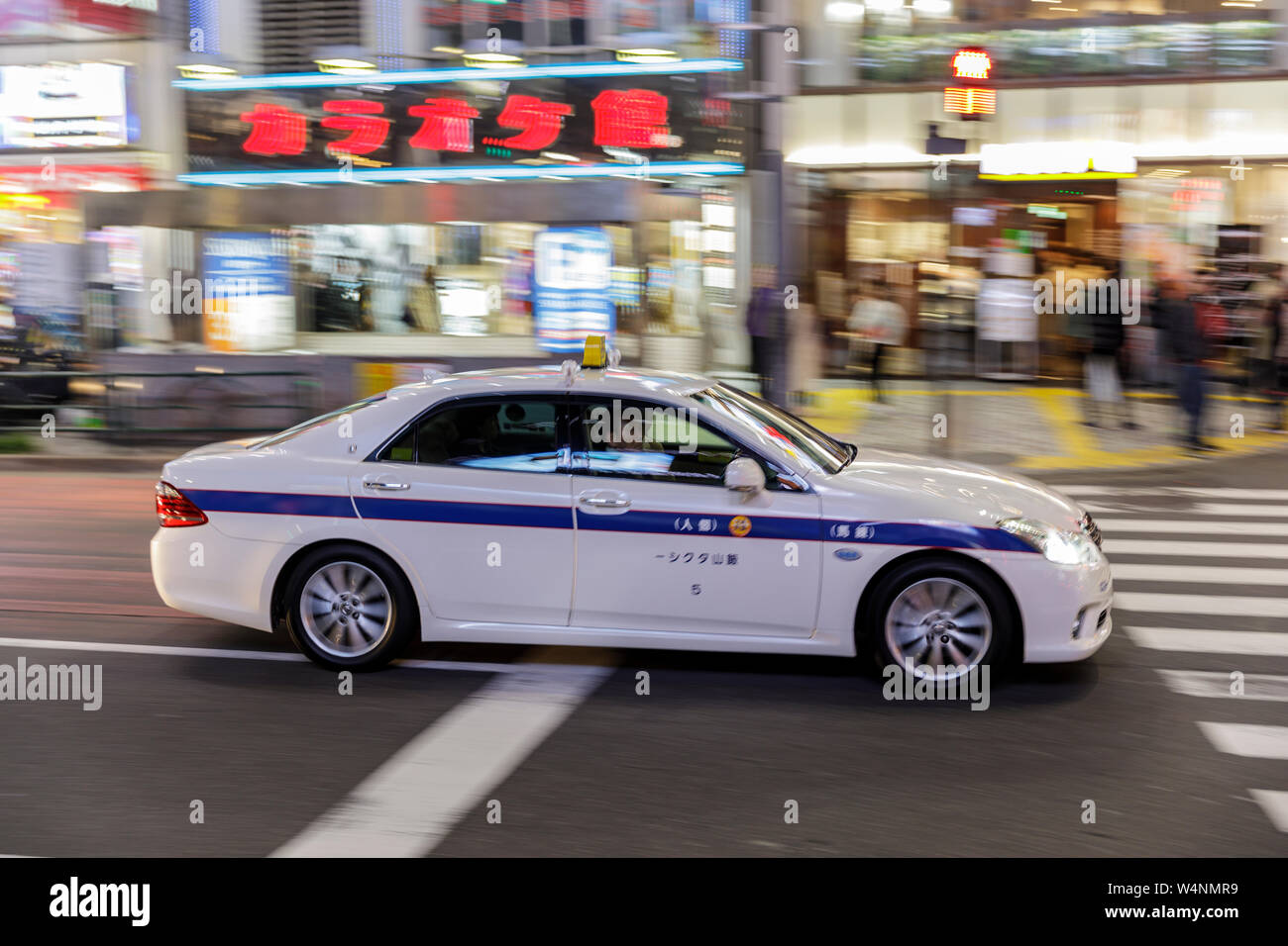Taxi speeding through the streets of Shinjuku, Tokyo. Stock Photo