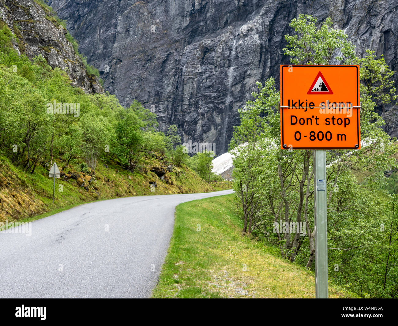 Narrow road, warning sign, landslide, dont stop, Norangsdal valley, Norway. Stock Photo