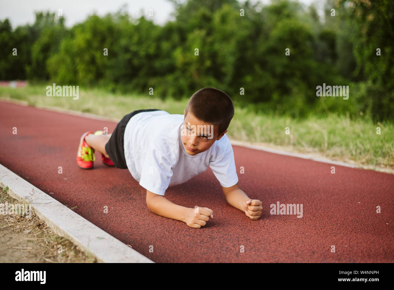 7 year old child is training to pull up on the horizontal bar. Emotions