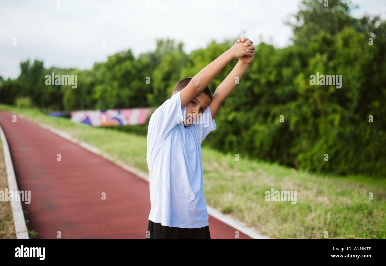 7 year old child is training to pull up on the horizontal bar. Emotions