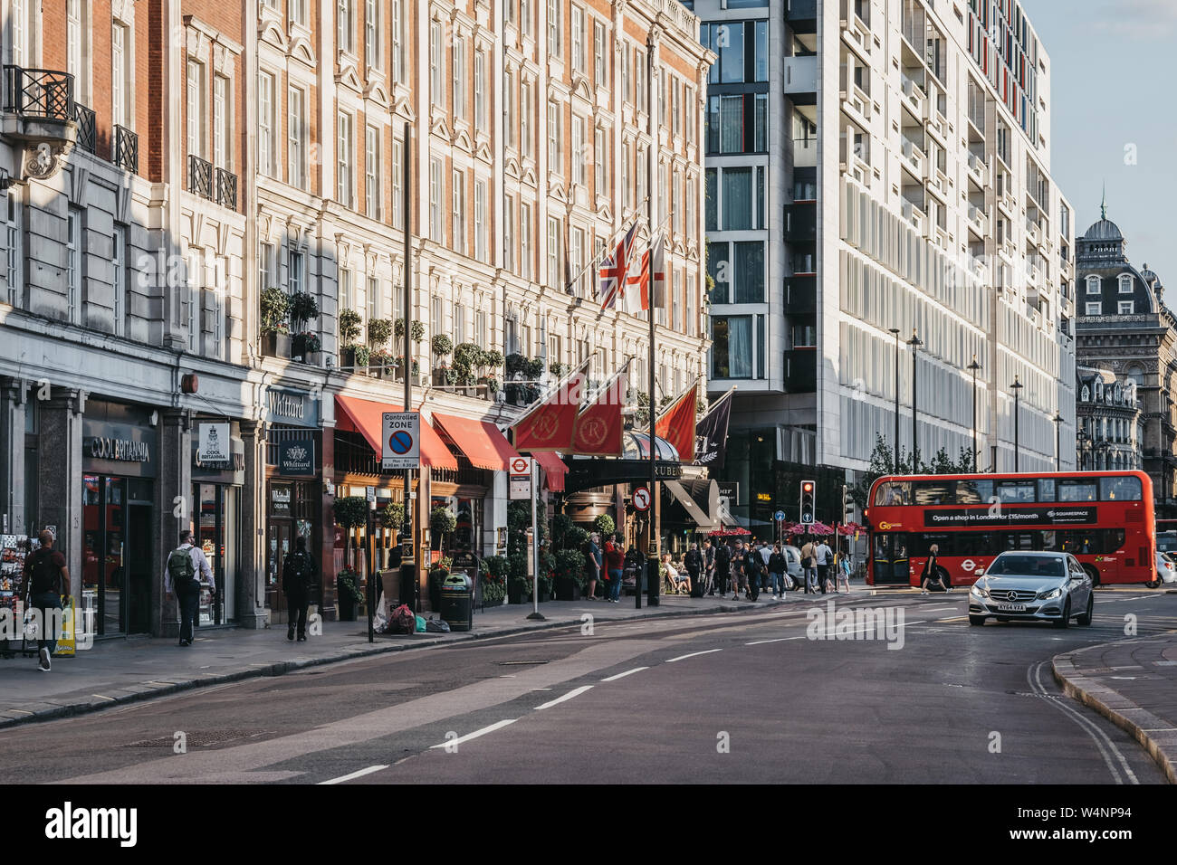 London, UK - July 15, 2019: People walking past the shops and hotel on Buckingham Palace Road, a famous street in Victoria, London, that runs from Buc Stock Photo
