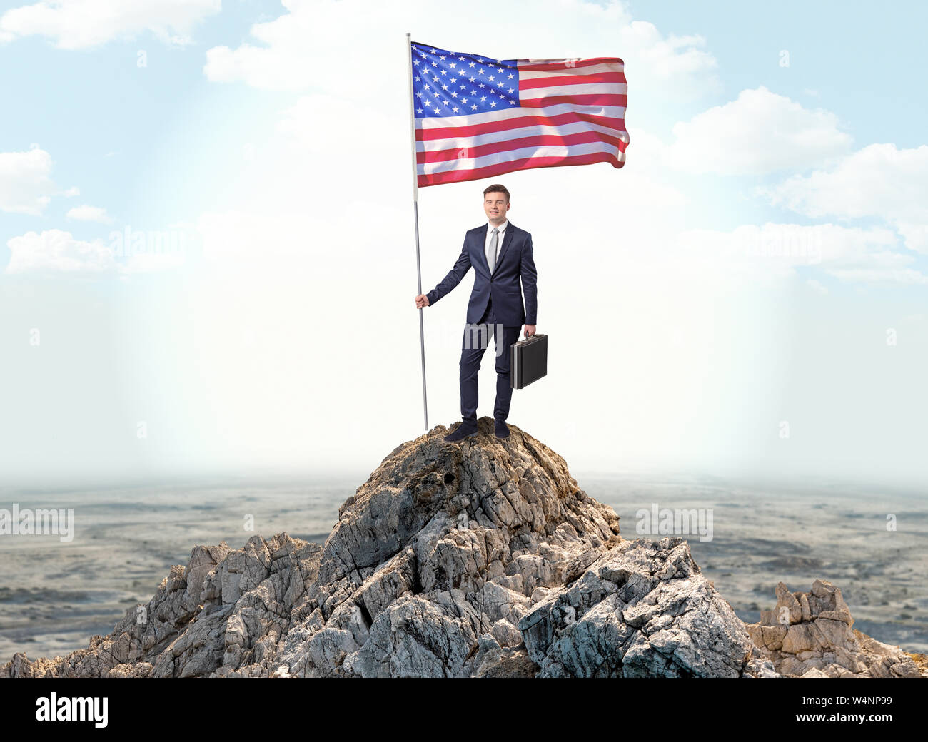 Successful businessman on the top of a mountain holding victory flag ...