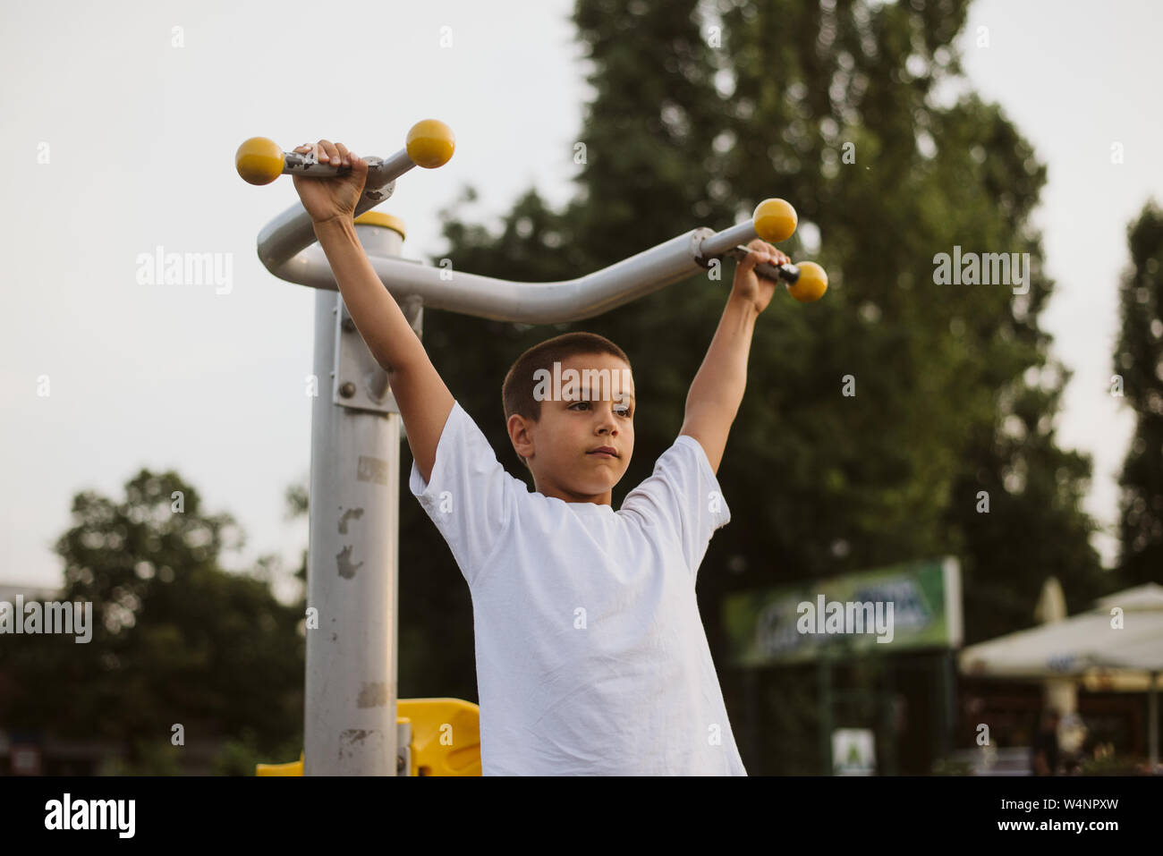 7 year old child is training to pull up on the horizontal bar. Emotions