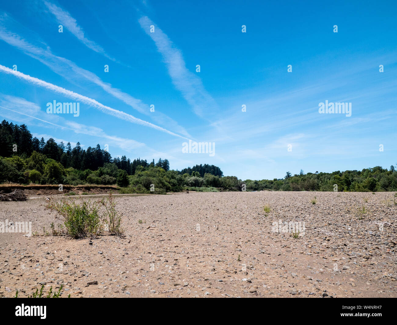 Dry stream bed and blue sky with clouds Stock Photo