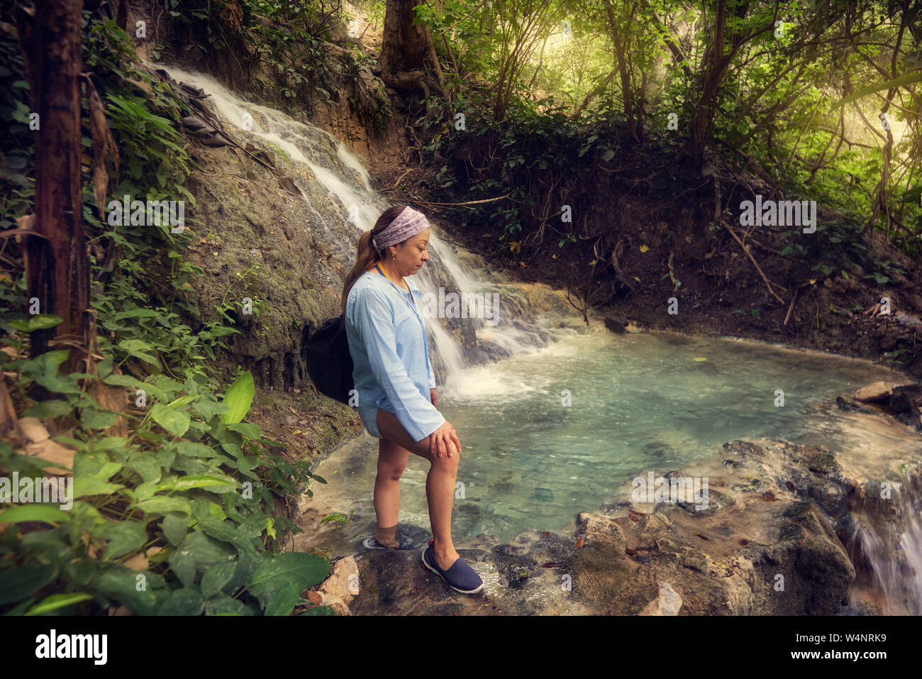 Female tourist in Mexico looking thermal river in the middle forest Stock Photo
