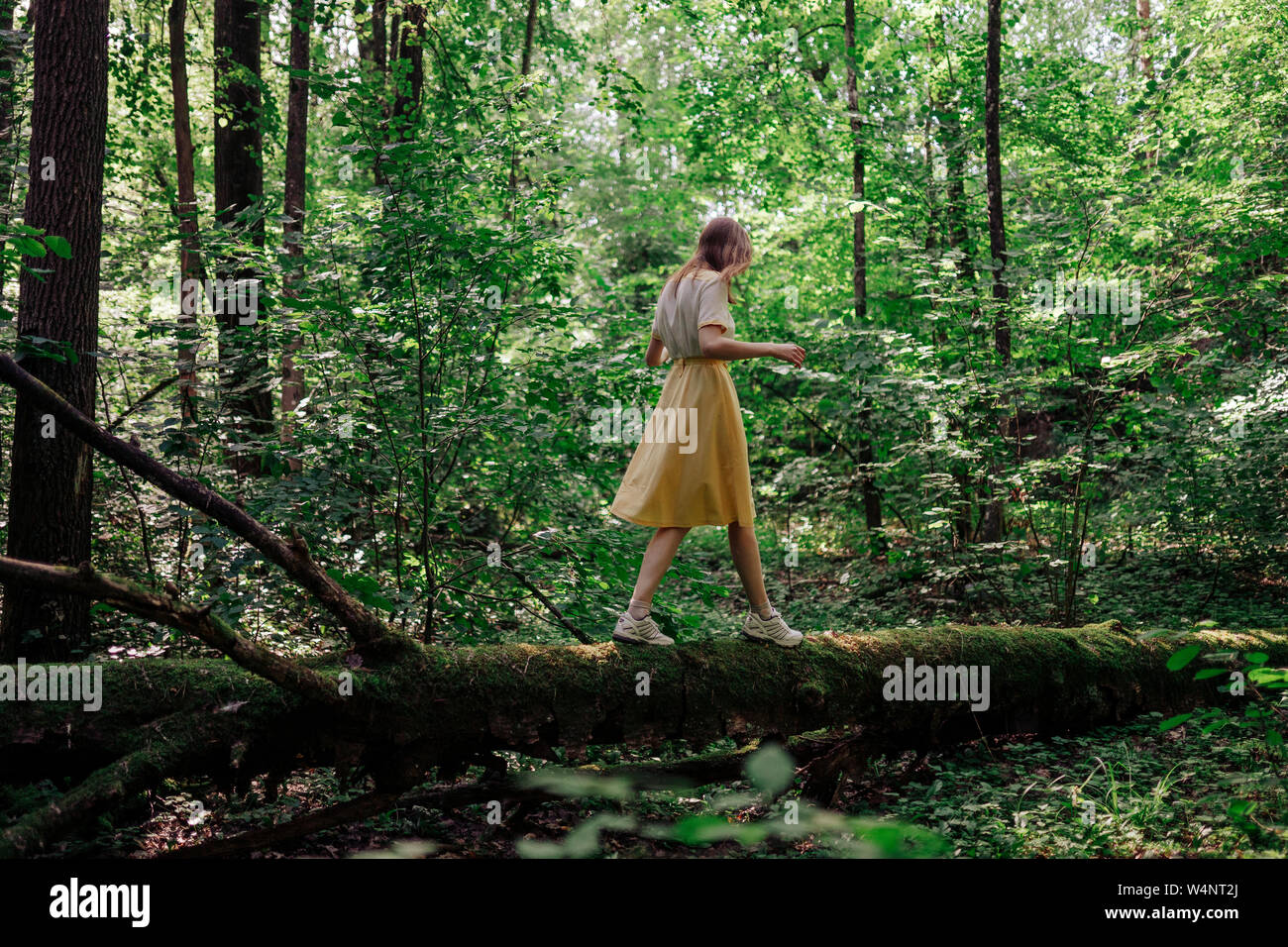 girl walking through forest