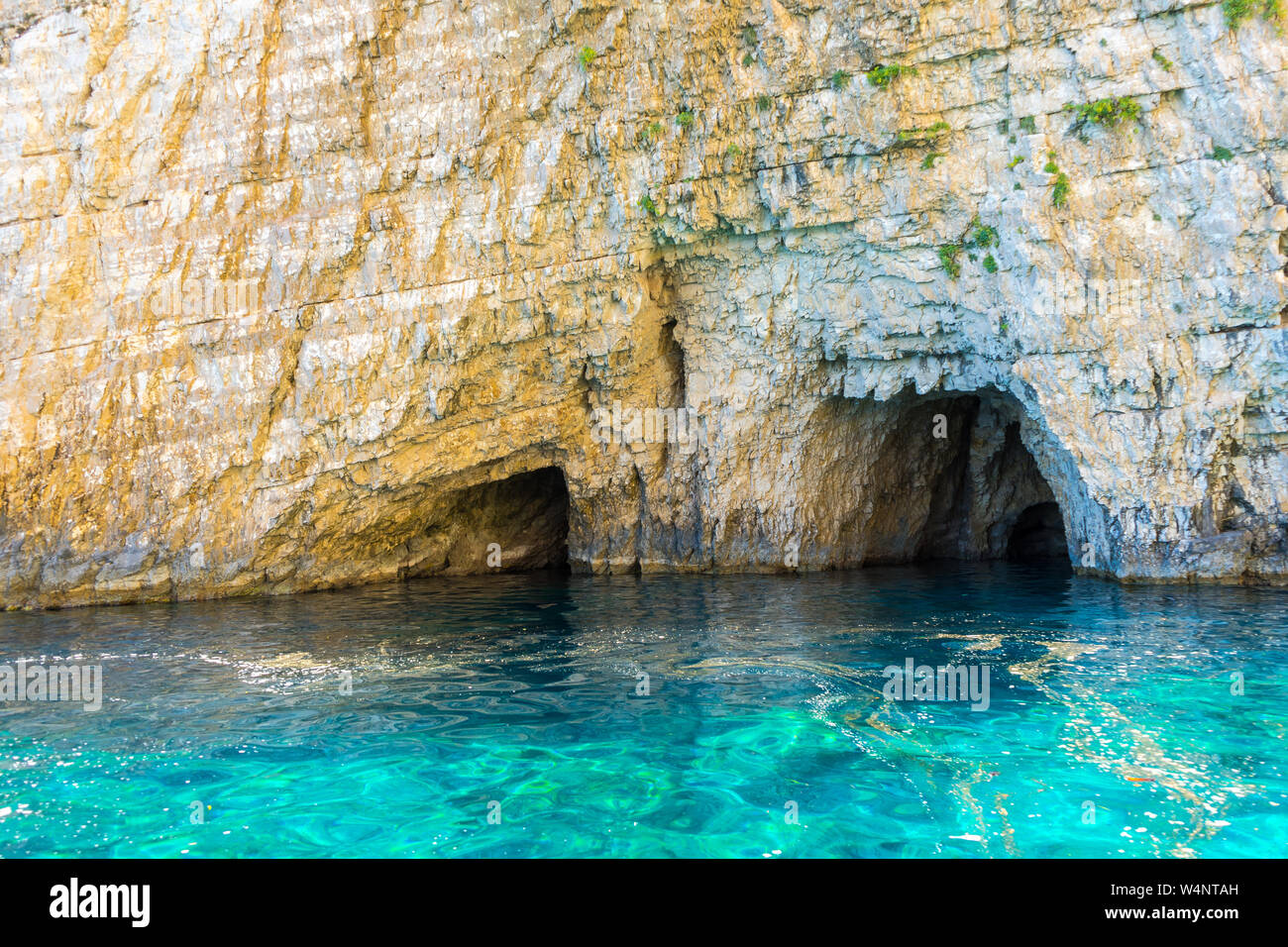 Greece, Zakynthos, White chalk cliff stone wall and keri caves with ...