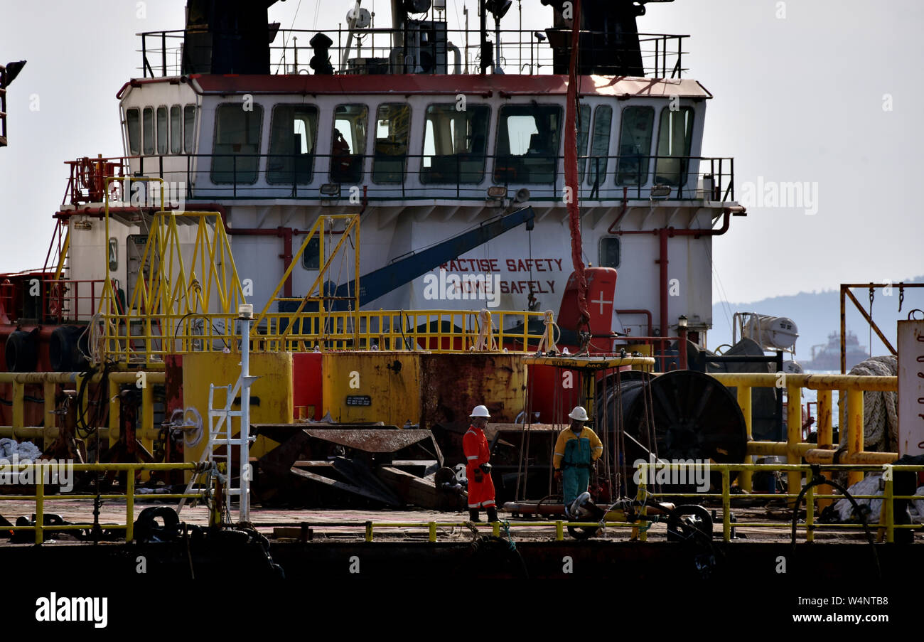 marine crew prepare safety basket for oil platform persona being transfer by crane operator Stock Photo