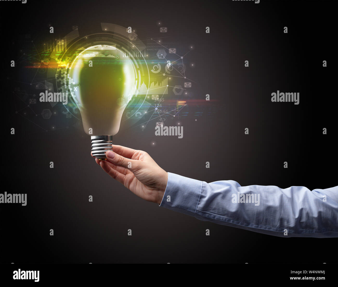 Hand holding light bulb on dark background. New business idea concept ...