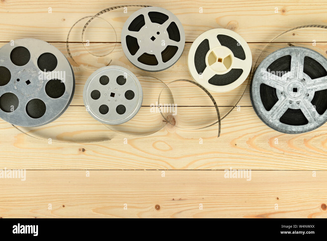 Obsolete cinema films on wooden surface of table. Copy space Stock Photo