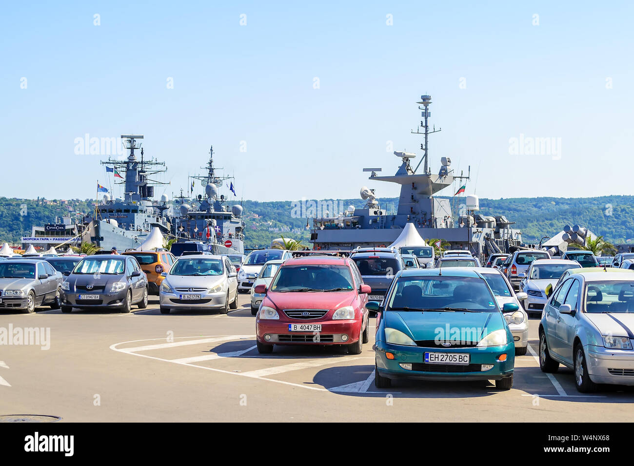 Varna, Bulgaria, July 20, 2019. Three large gray modern warships at the pier in the seaport of Varna. View from the parking lot on a sunny summer day. Stock Photo