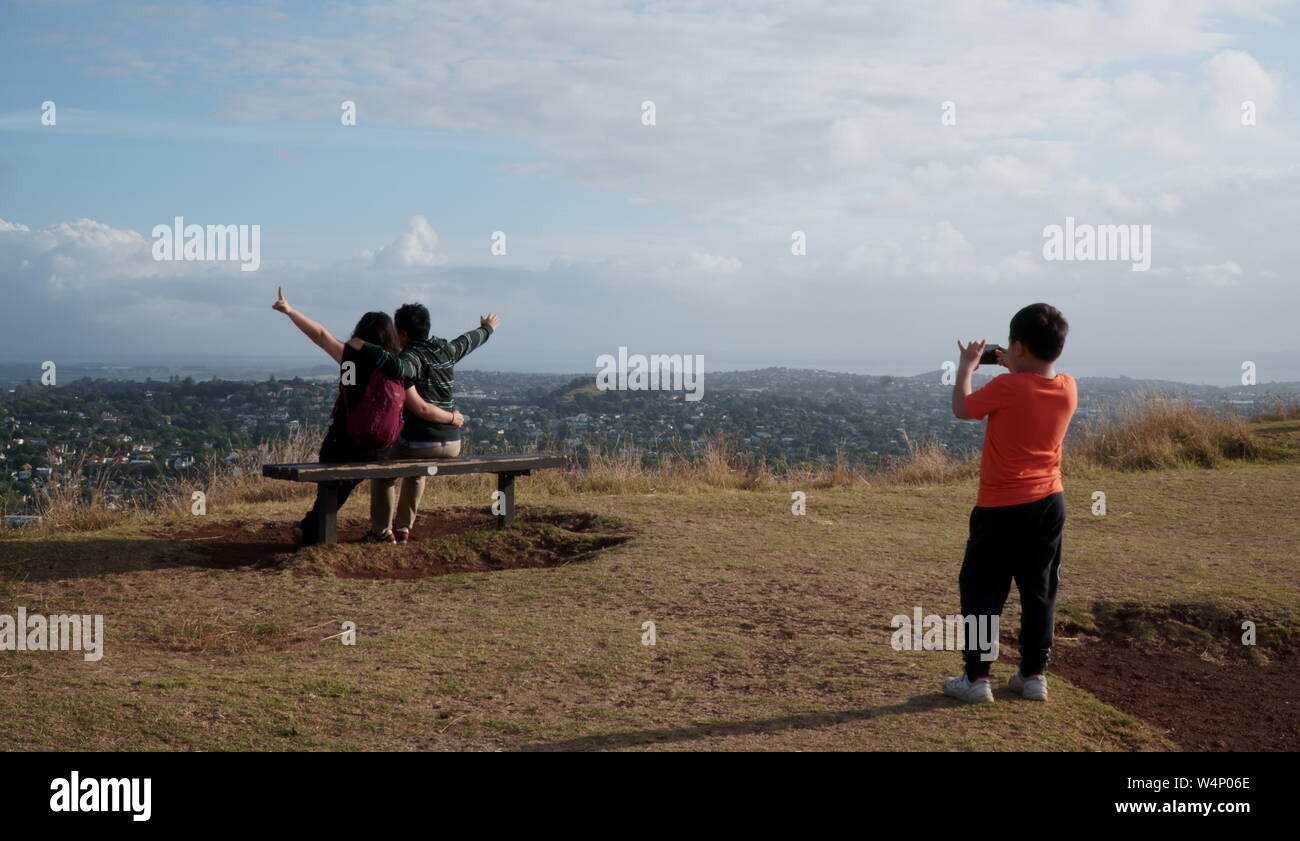 Child photographing parents on vacation in Auckland New Zealand Stock Photo