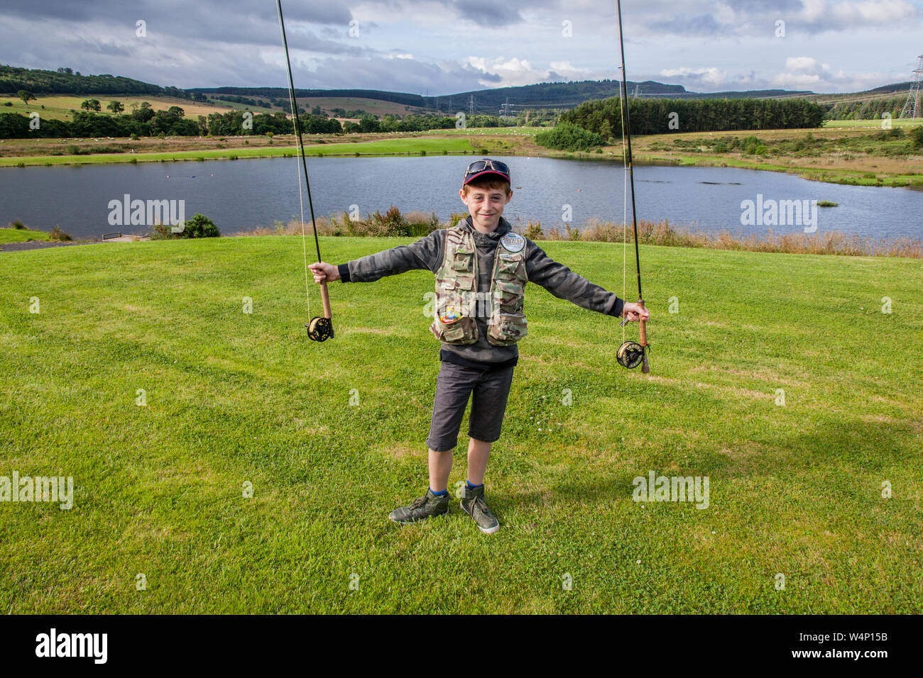 10 year old boy fishing at Thrunton Long Crag Trout fishery, Thrunton