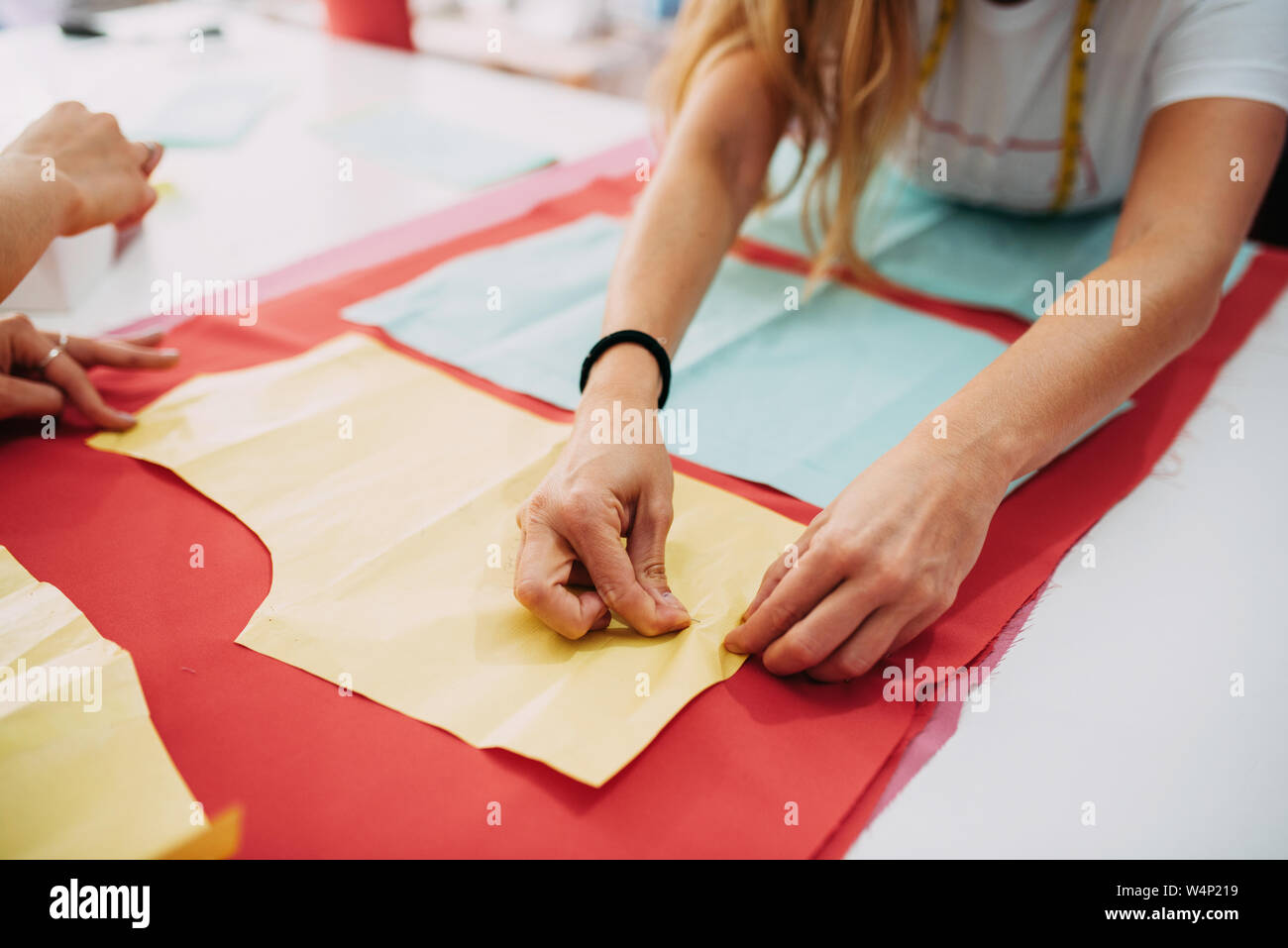 Fashion designer preparing fabric to cut Stock Photo