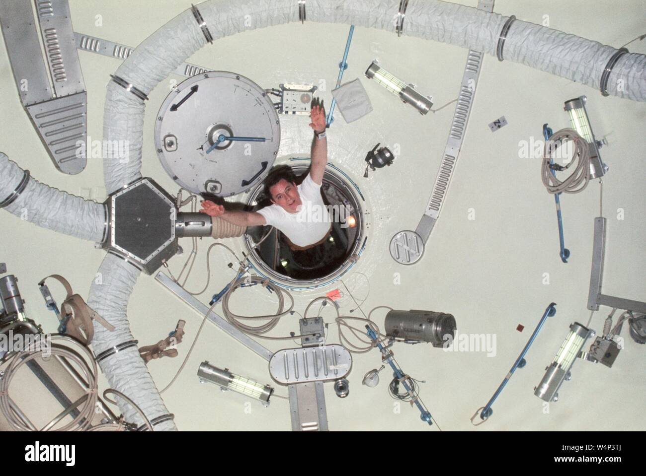 Scientist-astronaut Edward G Gibson sailing through airlock module hatch of the Skylab 4, demonstrating the effects of zero-gravity, February, 1974. Image courtesy National Aeronautics and Space Administration (NASA). () Stock Photo