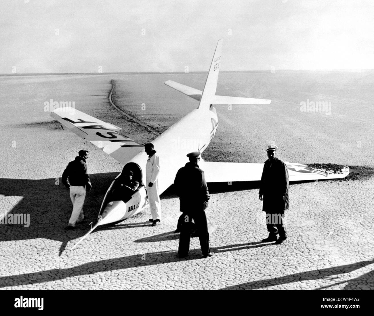 NASA engineers and pilots gather around the X-2 aircraft with a collapsed nose landing gear after landing on the first glide flight at Edwards Air Force Base, Kern County, California, 1952. Image courtesy National Aeronautics and Space Administration (NASA). () Stock Photo