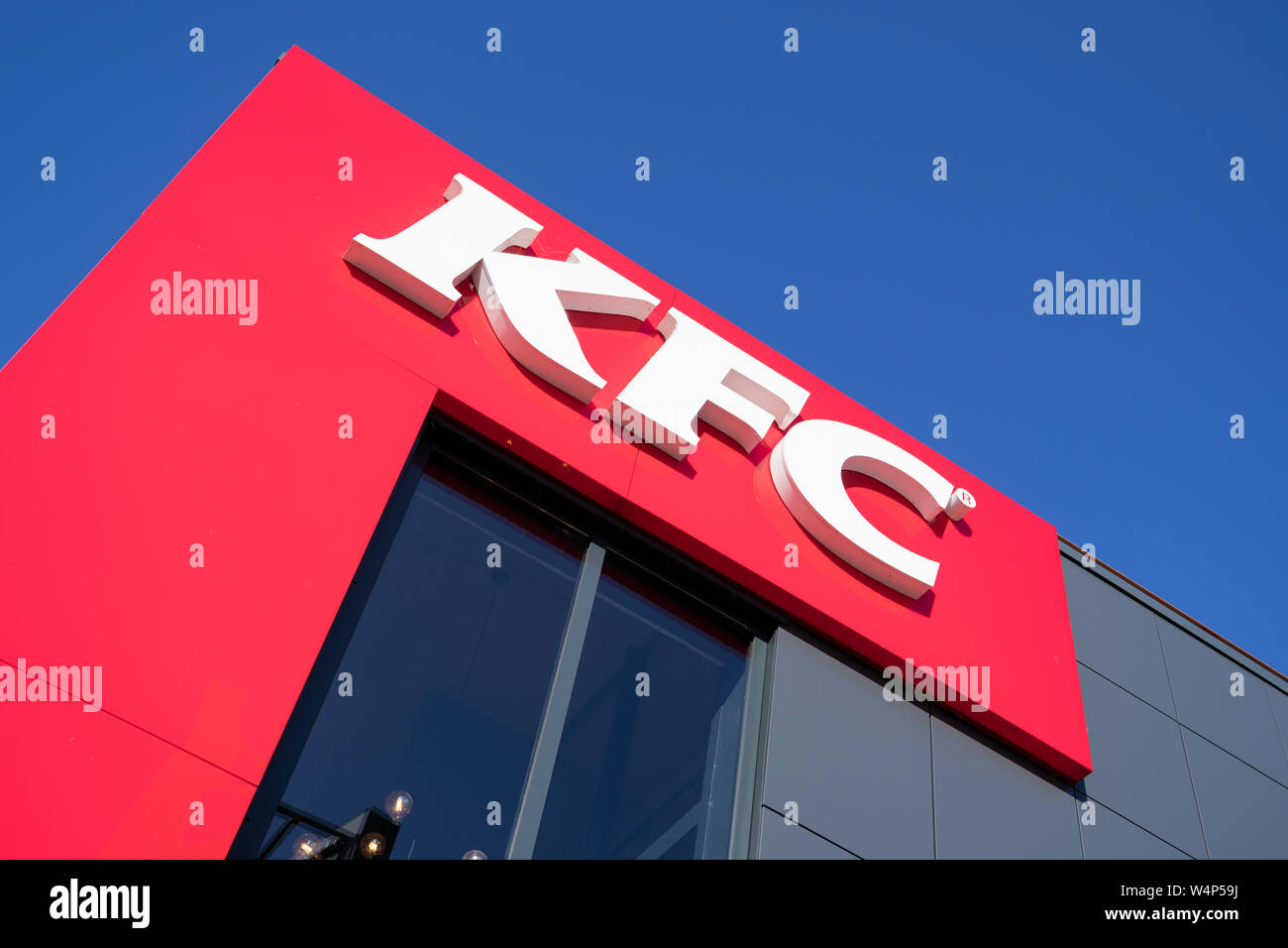 KFC sign at fast food restaurant. Kentucky Fried Chicken (KFC) is the world's second largest restaurant chain with almost 20,000 locations globally. Stock Photo