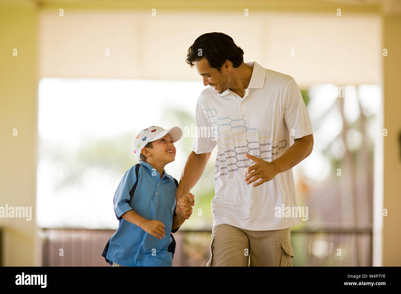 Father and son walking hand in hand Stock Photo - Alamy