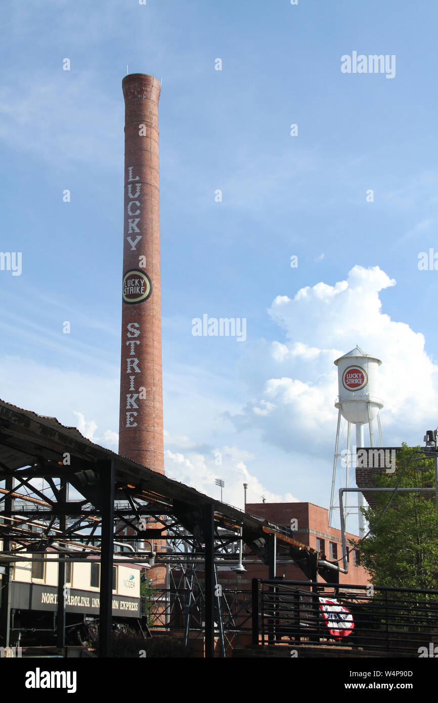 The Lucky Strike smokestack and water tower in the American Tobacco Historic District in Durham, NC, USA Stock Photo