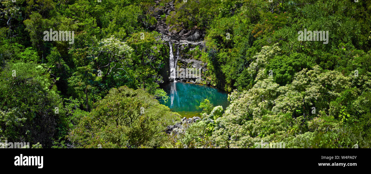 Waterfall surrounded by lush foliage and reflected in a lake Stock ...