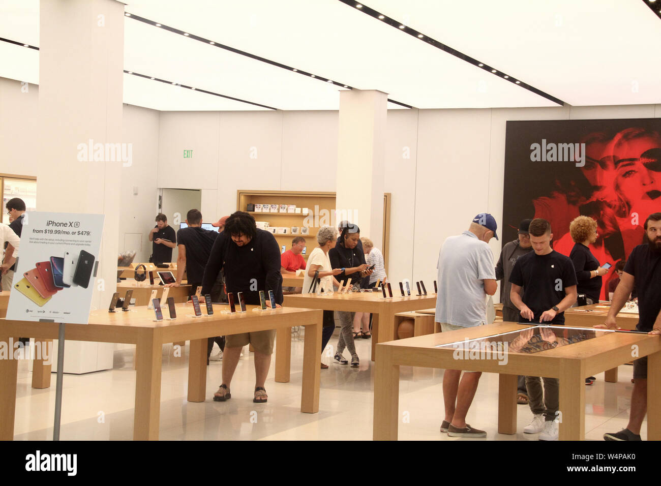 People checking cell phones in store inside Mall in Raleigh, NC, USA