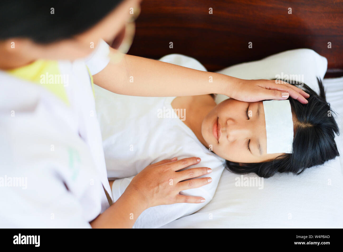 fever child with nurse or doctor measuring temperature of kid sick