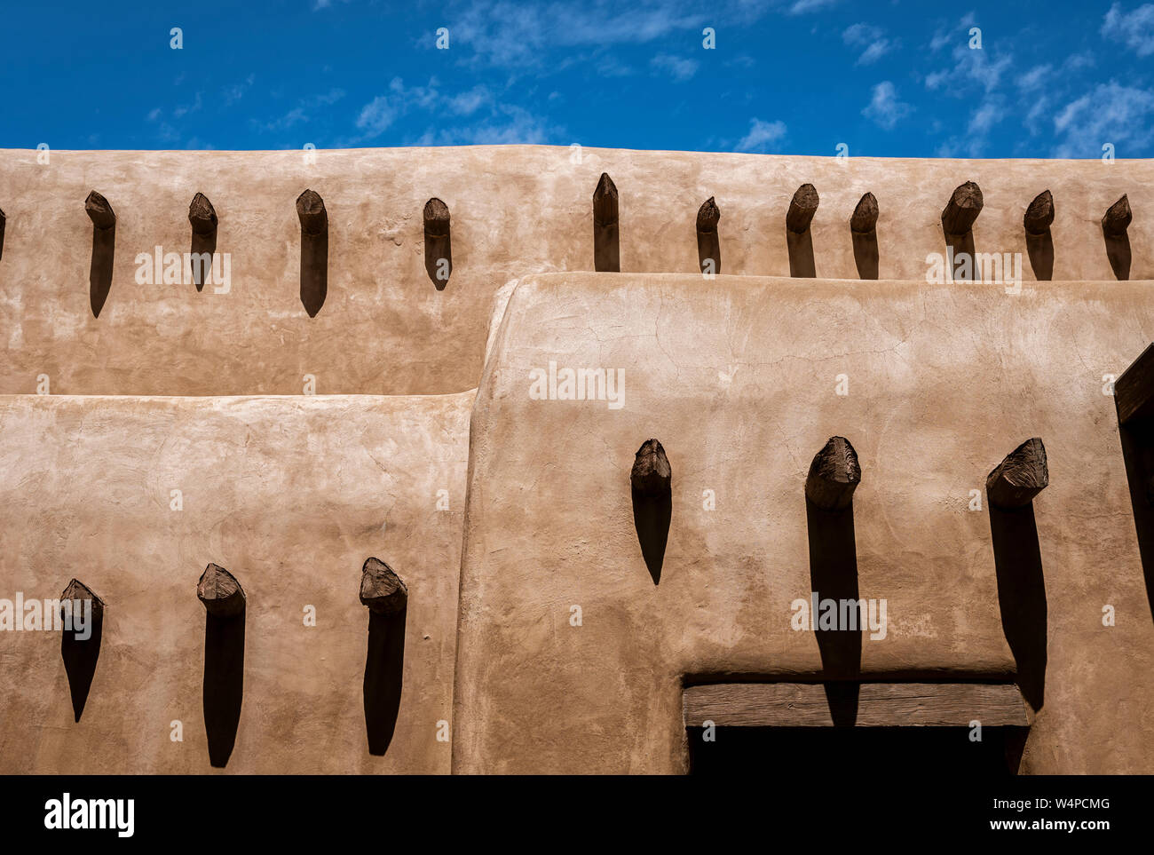 Santa Fe, New Mexico, adobe wall with vigas and shadows. Stock Photo