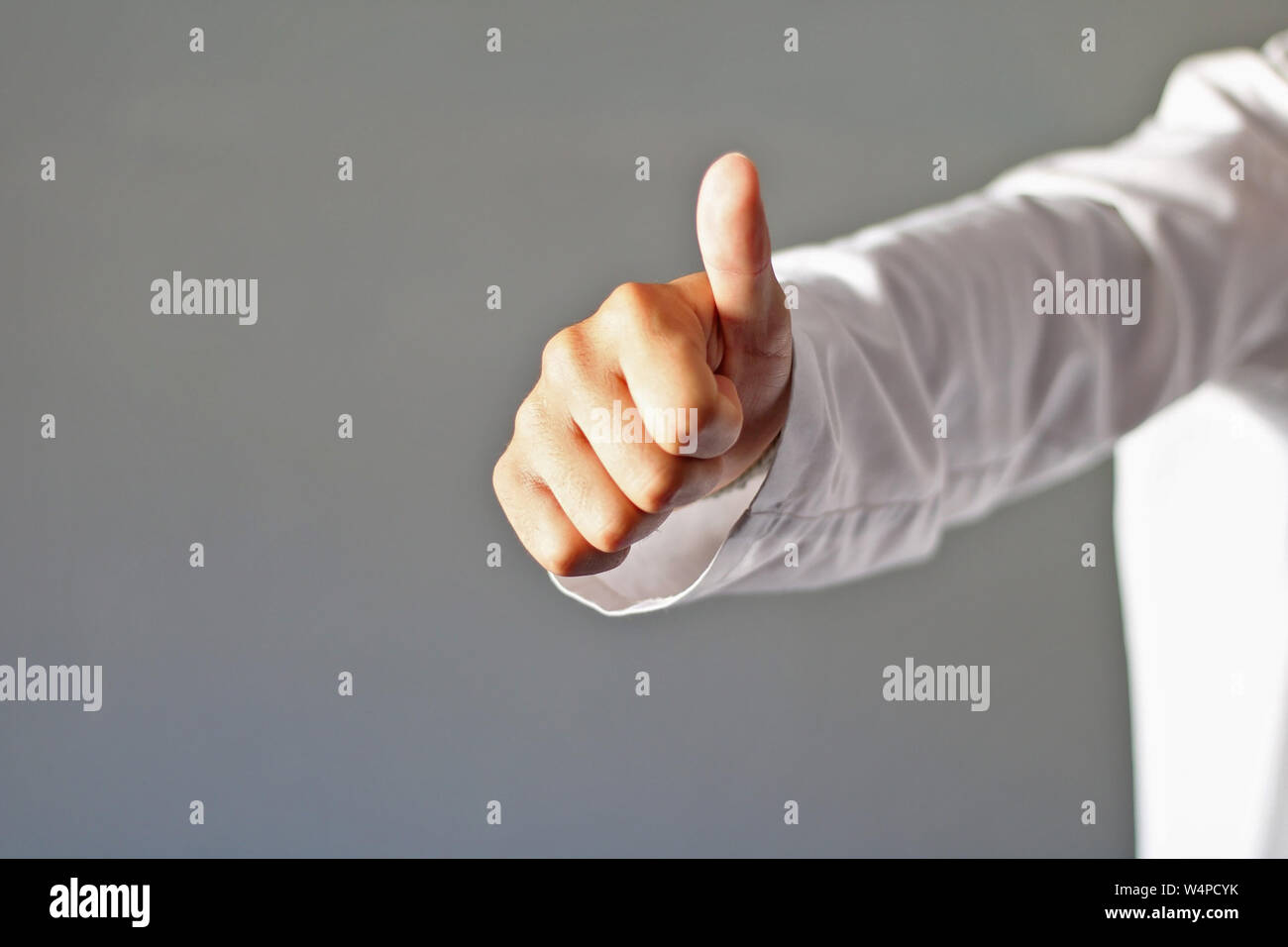 Doctor dressed in white doing the okey. Stock Photo