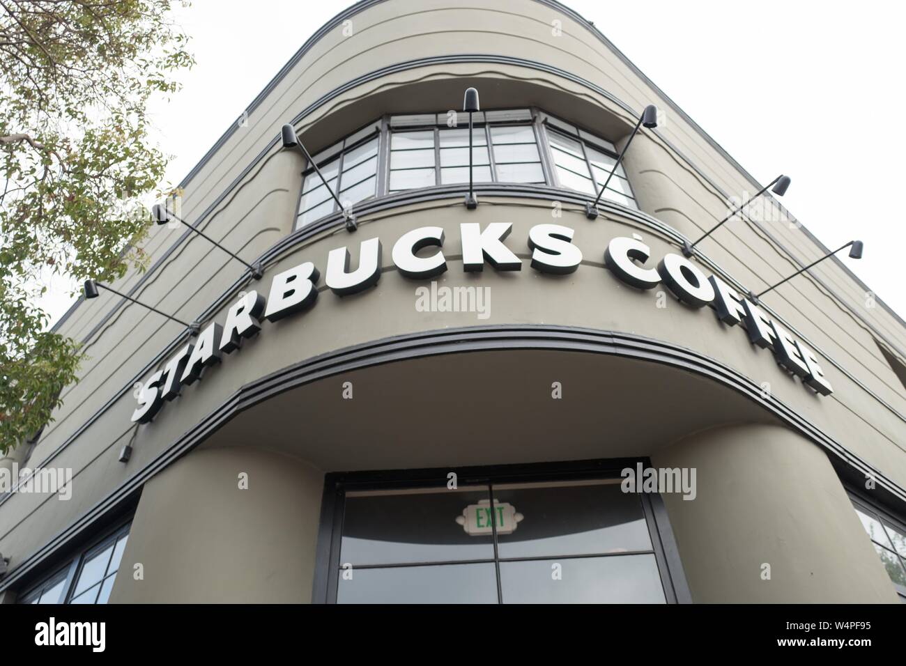 Low-angle view of sign on facade of Starbucks coffee shop in the main downtown area on Alameda Island, Alameda, California, August 13, 2018. () Stock Photo