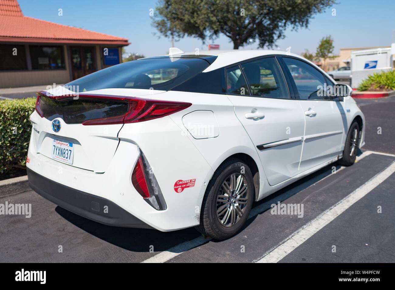 Rear view of a white Toyota Prius Prime plug in hybrid electric car, with California Clean Air Vehicle decal, in Dublin, California, August 20, 2018. () Stock Photo