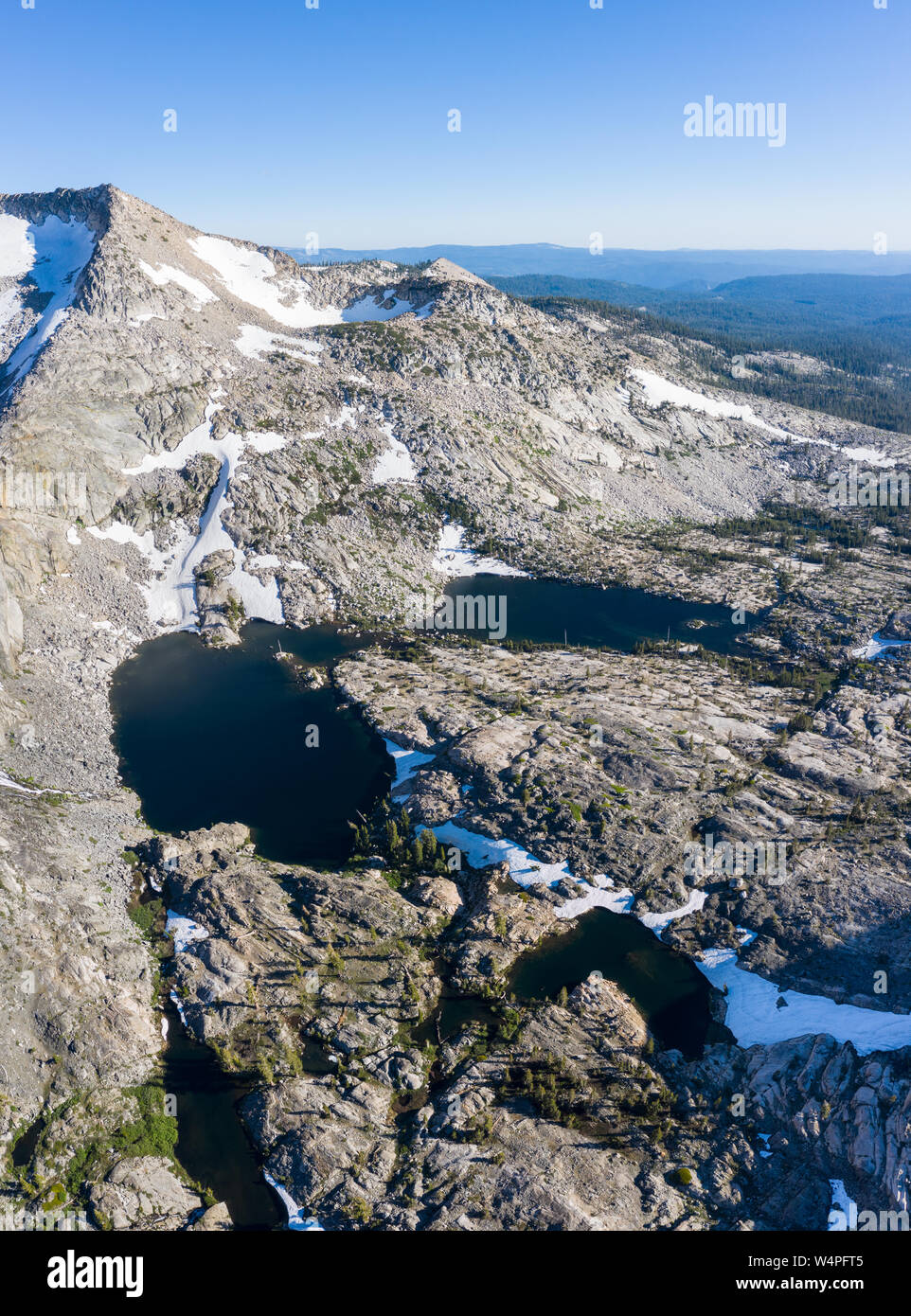 High granite mountains surround beautiful lakes in the Desolation Wilderness, California. This mountainous area is a popular backpacking destination. Stock Photo