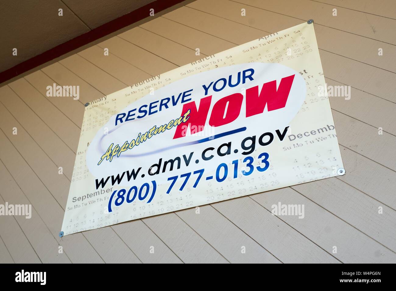 Sign advertising service which allows visitors to book advanced appointments at the California Department of Motor Vehicles (DMV) office in Plesanton, California, August 28, 2018. () Stock Photo