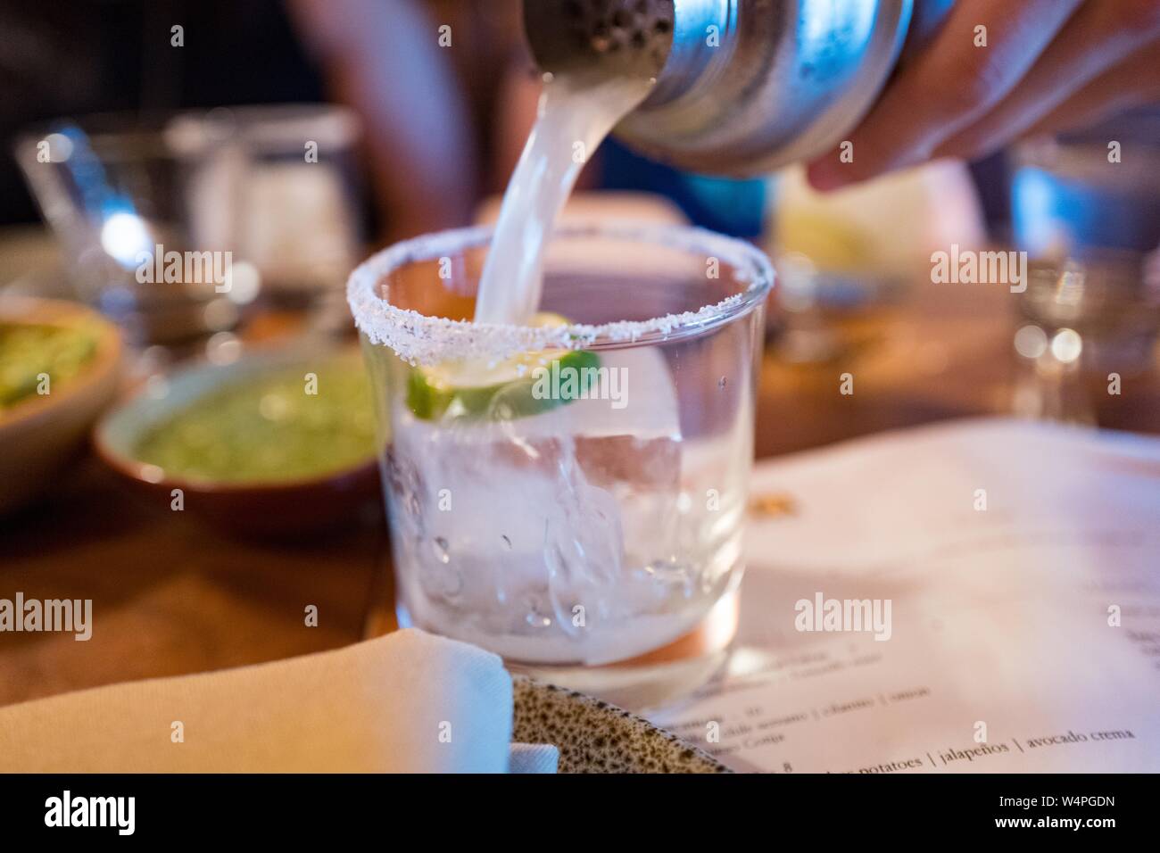 Close-up of hand of a man pouring the signature Copita margarita into a salt rimmed glass at Copita Mexican cuisine restaurant in Sausalito, California, August 5, 2018. () Stock Photo