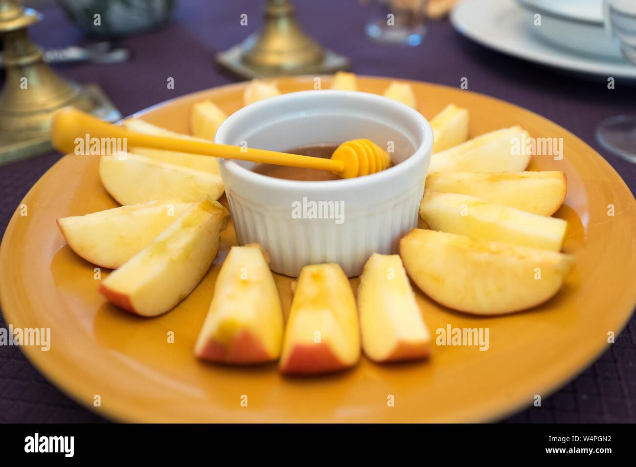 Traditional apples and honey dish on Rosh Hashanah table; apples and
