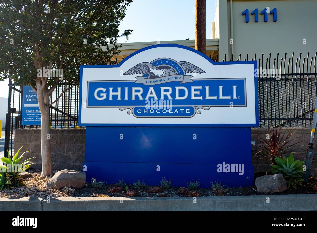 Sign with logo for iconic San Francisco gourmet chocolate company Ghirardelli at the company's factory and headquarters in San Leandro, California, September 10, 2018. () Stock Photo