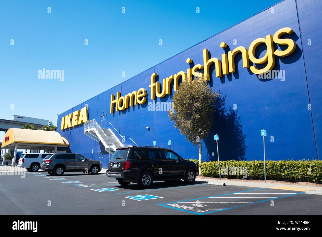 Facade with logo visible at the IKEA Home Furnishings store in downtown Emeryville, California, with cars parked in front, September 18, 2018. () Stock Photo