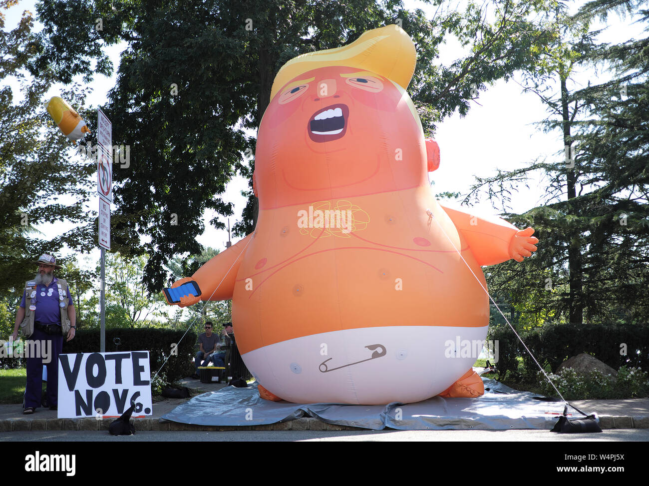 Members of the public view a Donald Trump baby balloon on display during a  street fair in Maplewood, New Jersey Stock Photo - Alamy