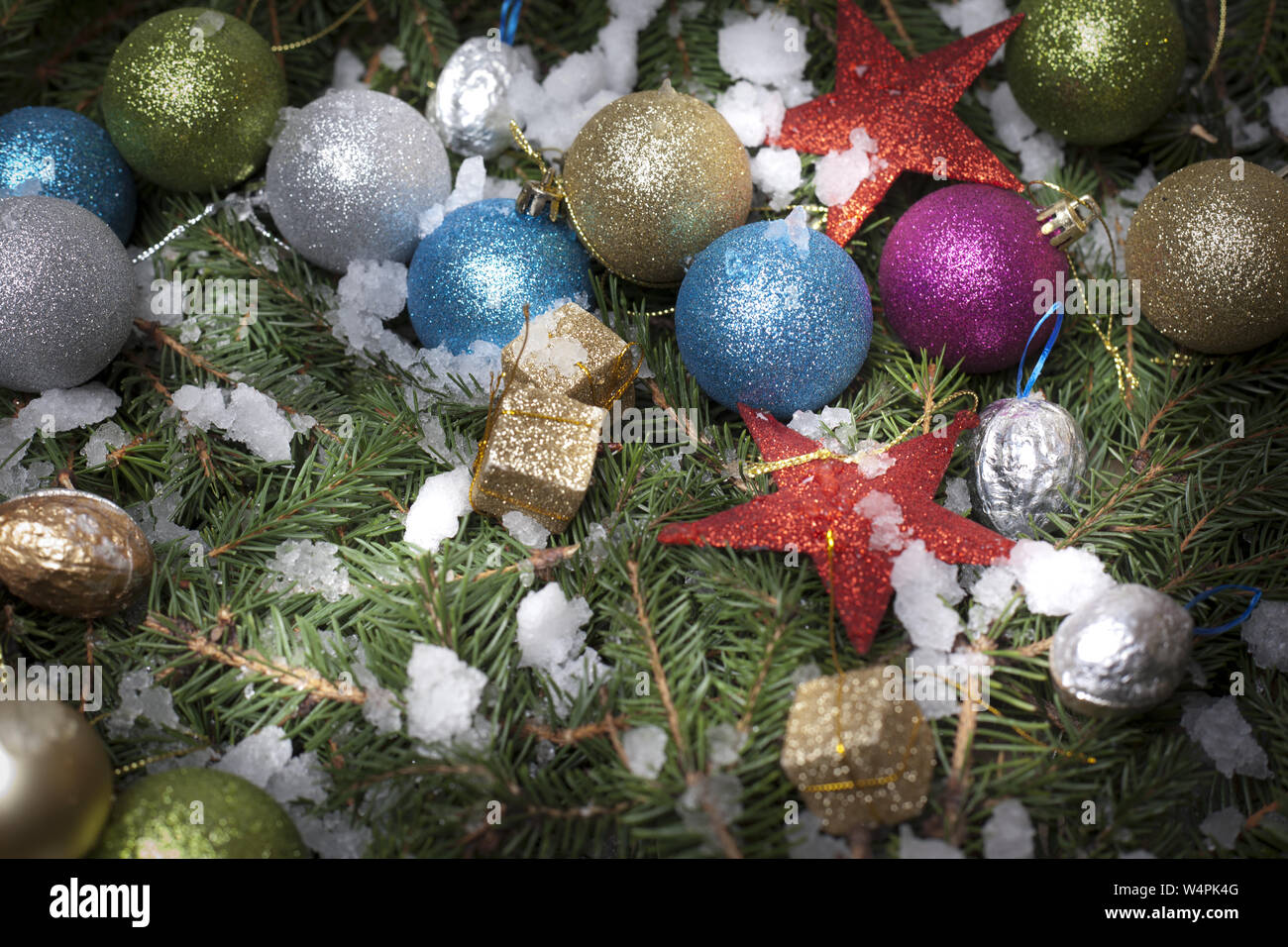 Christmas decoration ball and gift on tree needles with ice Stock Photo