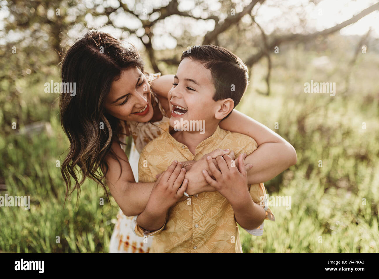 Close up view of mother and son hugging and laughing together Stock Photo