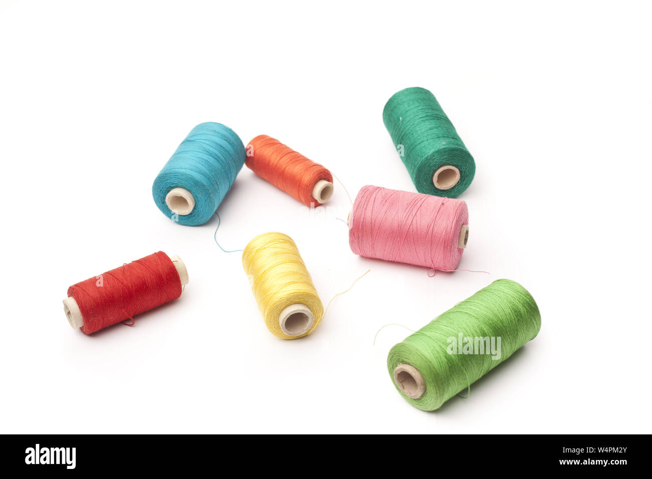 Colorful threads on a white background Stock Photo - Alamy