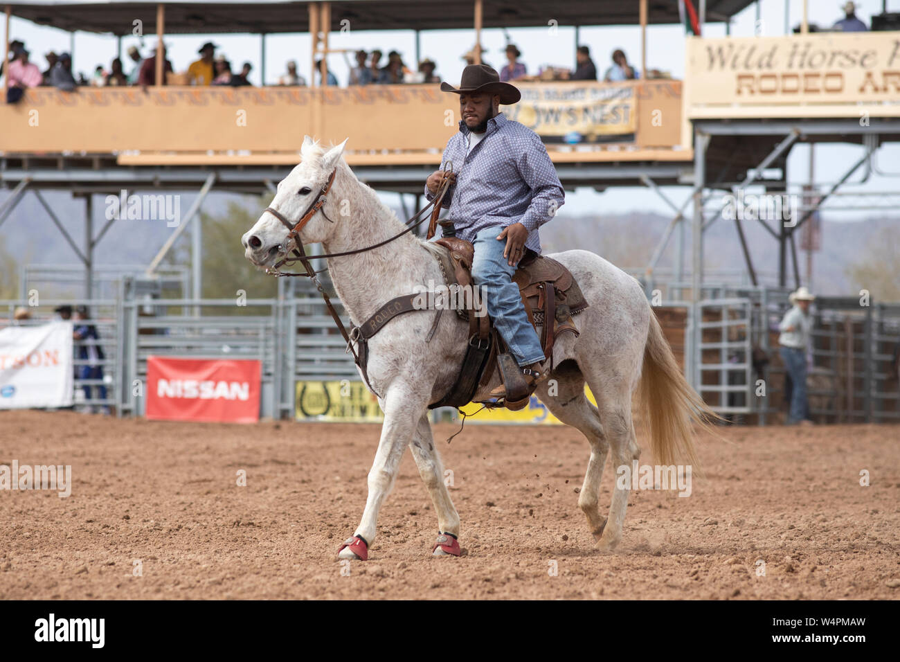 A cowboy enters the ring on horseback at the Arizona Black Rodeo Stock