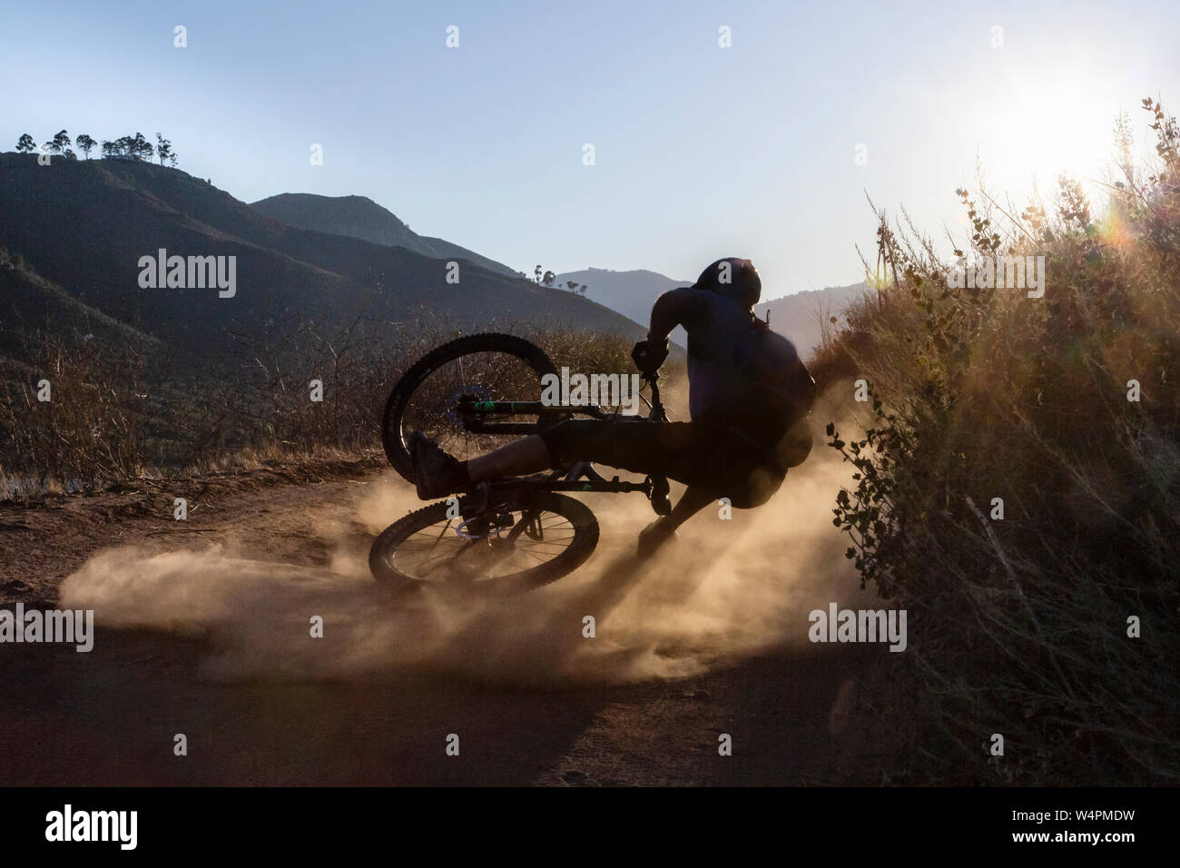 Mature man falling with mountain bike on trail in San Diego, CA Stock Photo