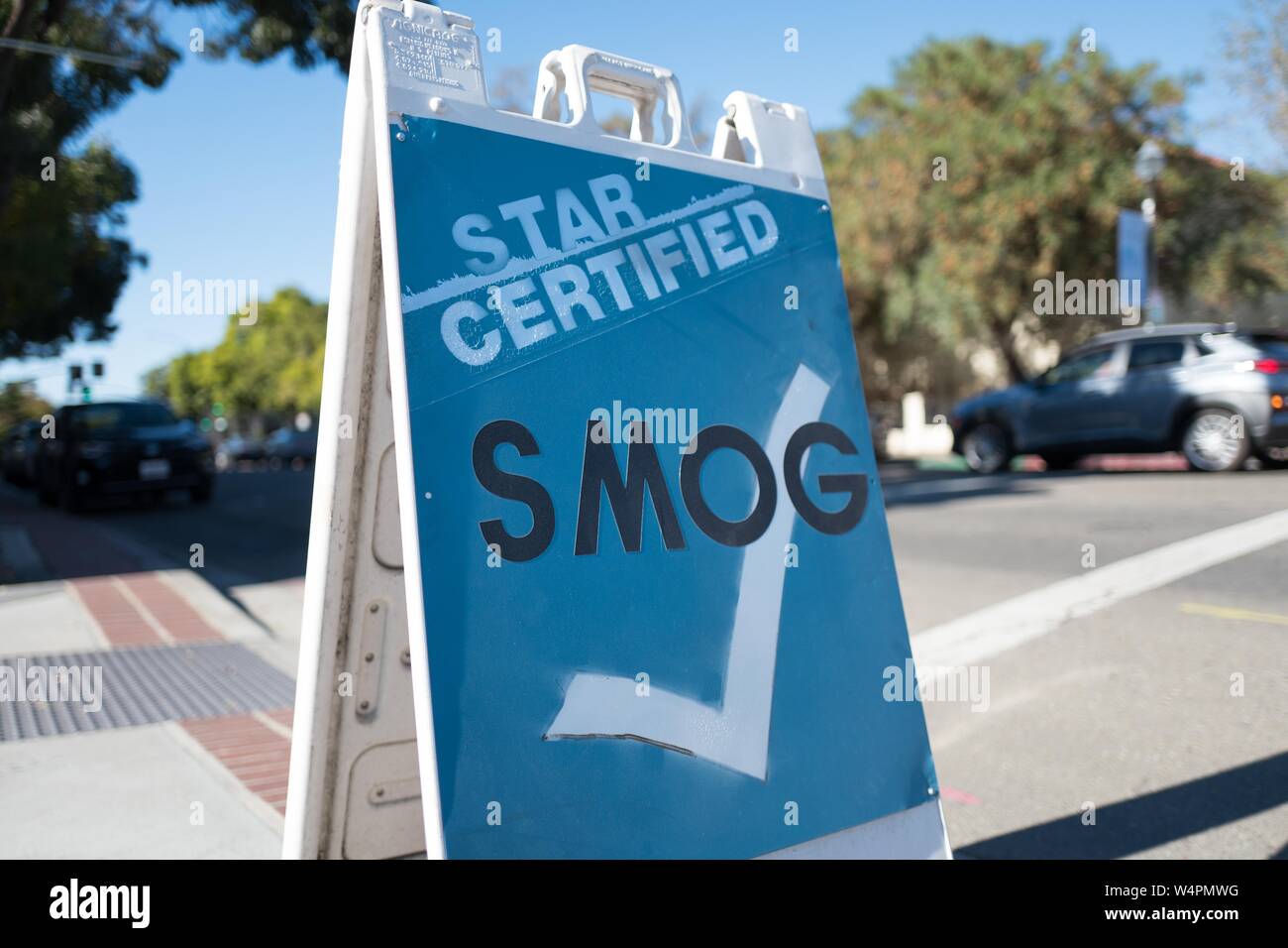 Low-angle view of sign for a California emissions inspection station, colloquially known as a Smog Station, which ensures that motor vehicles comply with California's stringent emissions requirements, in downtown Livermore, California, October 16, 2018. () Stock Photo