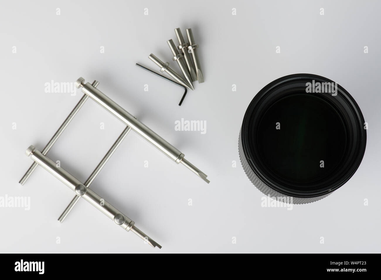 DSLR lens repair theme. Tools and lens isolated on white background