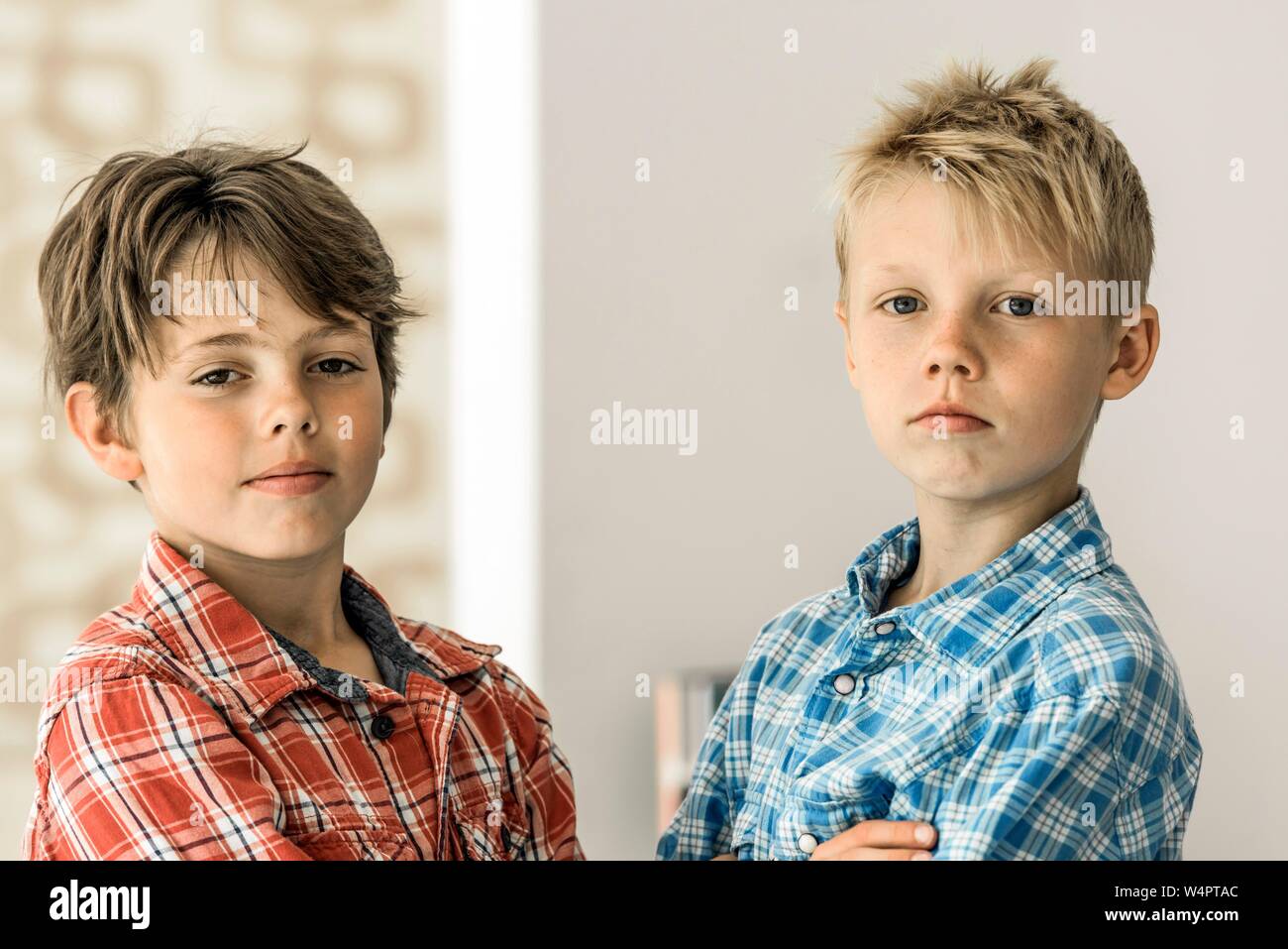 Two boys in plaid shirts, friends, 10 years old, looking cool into the camera, Germany Stock Photo