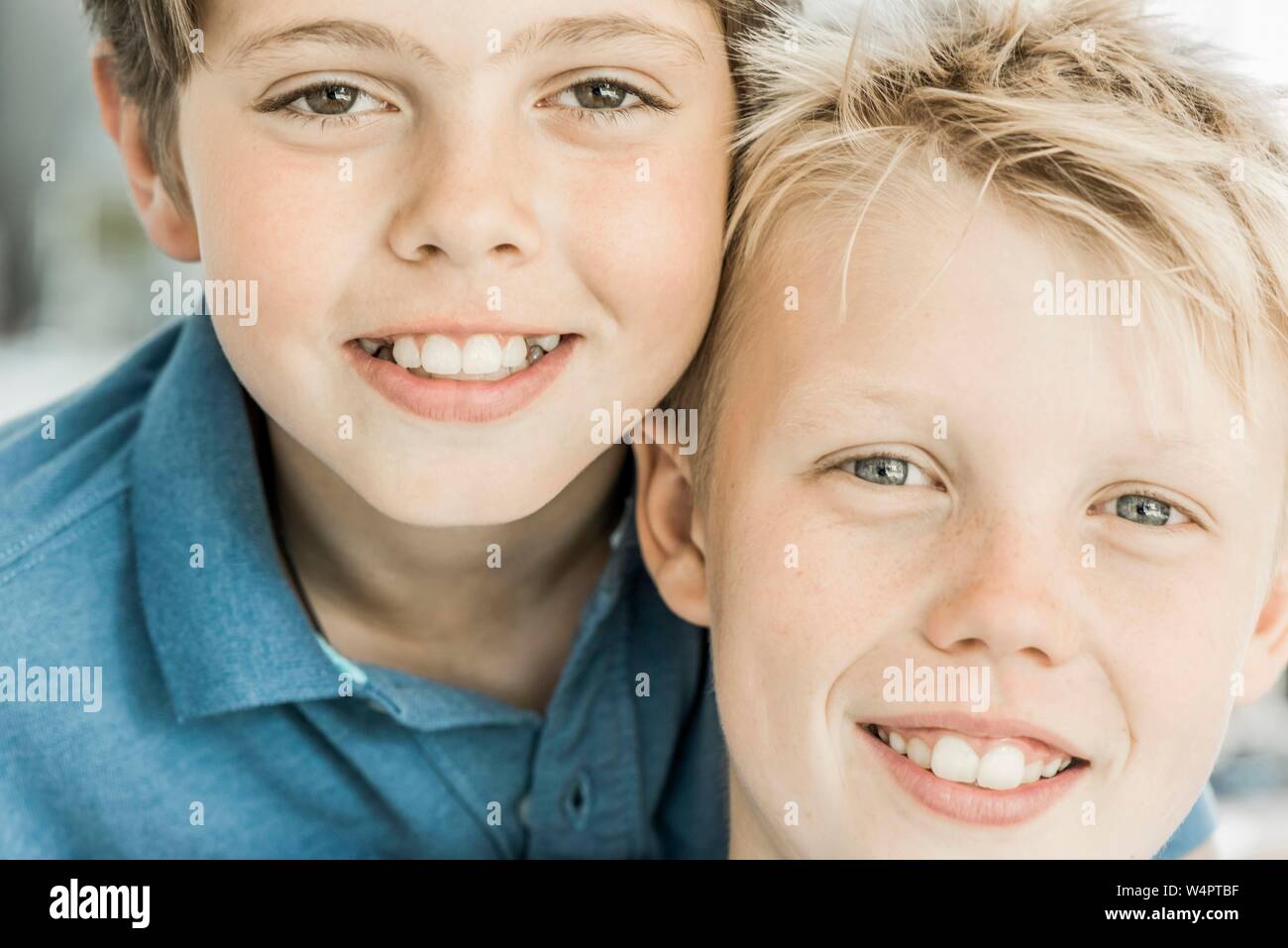 Two boys, friends, 10 years old, looking smiling into the camera, Portraits, Germany Stock Photo