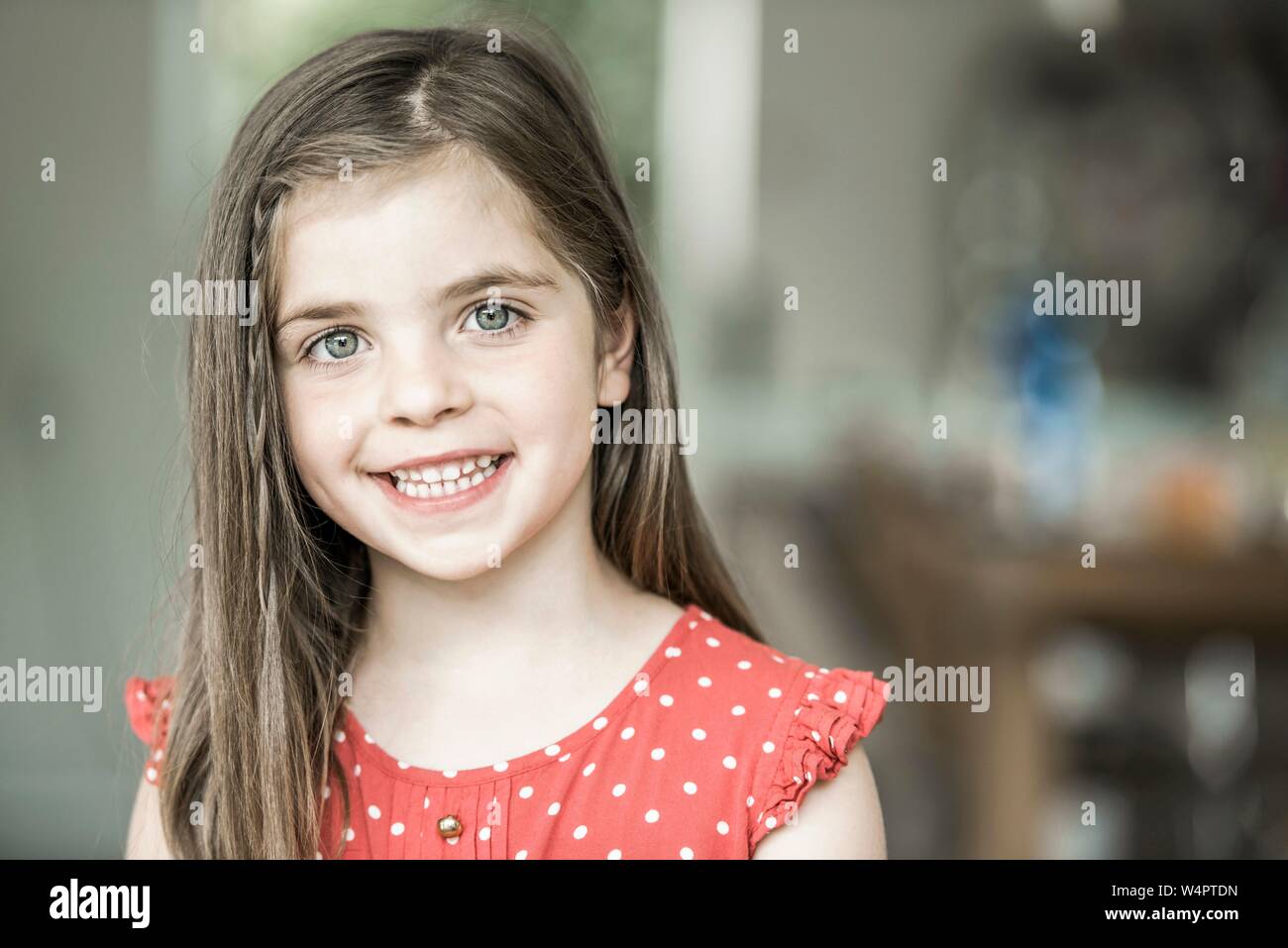 6-year-old girl looks into the camera, laughing, Germany Stock Photo